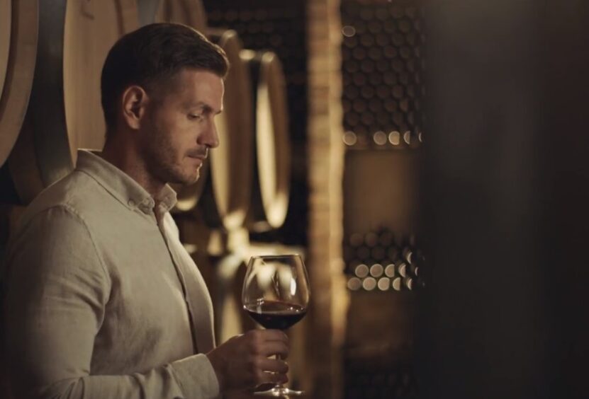 man thinking about wine brand name